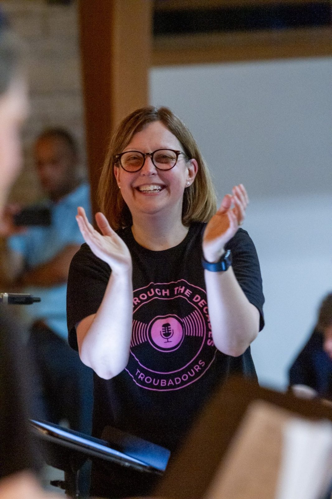 Cathy applauding her singers in rehearsal