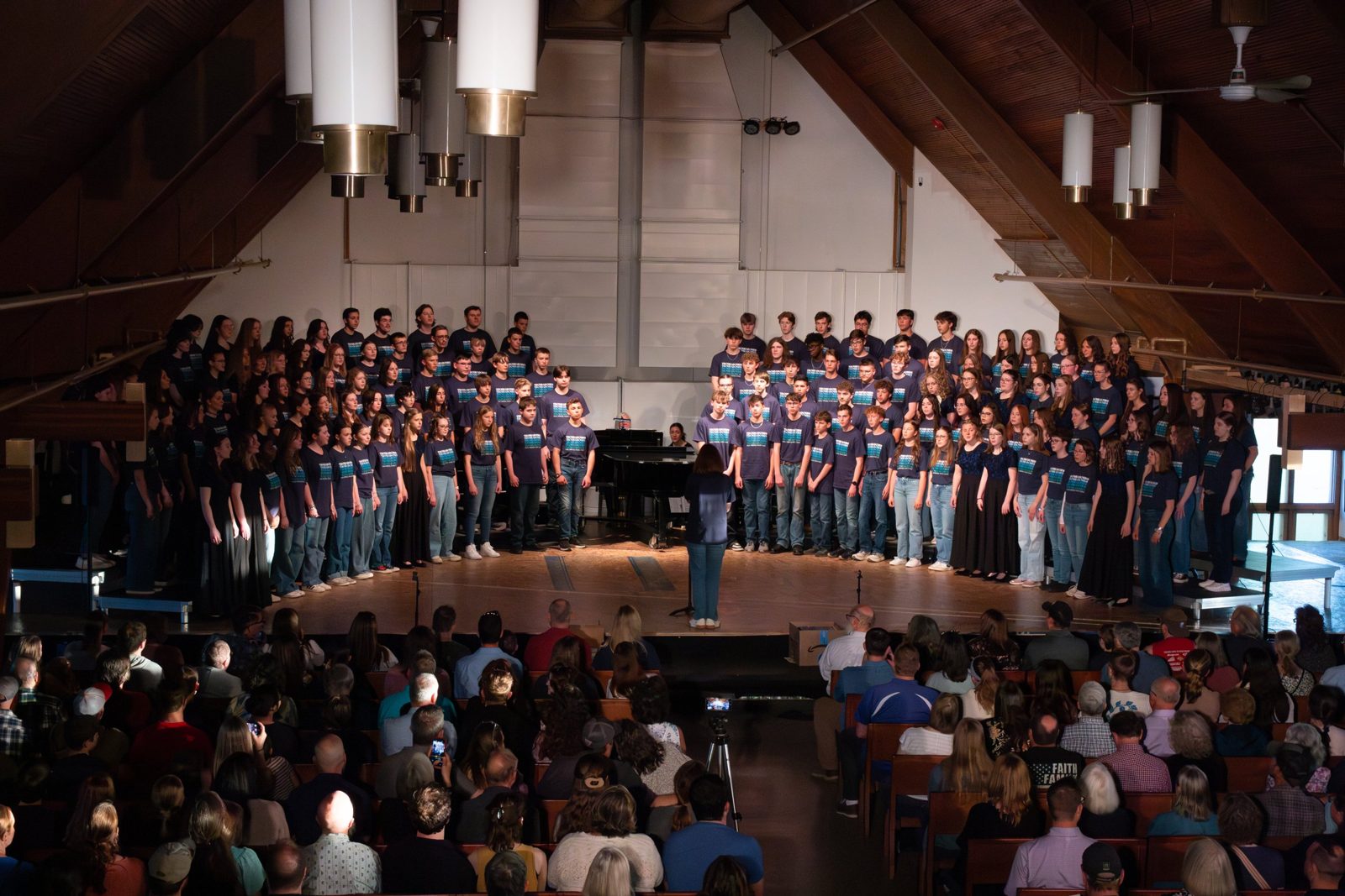 A large homeschool choir in concert before a full audience